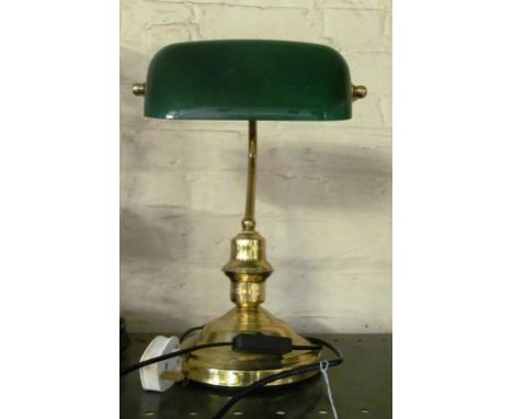 A desk lamp with green glass shade