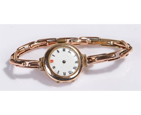 9 carat gold ladies wristwatch, the white enamel dial, manual wound, with 9 carat gold elasticated strap