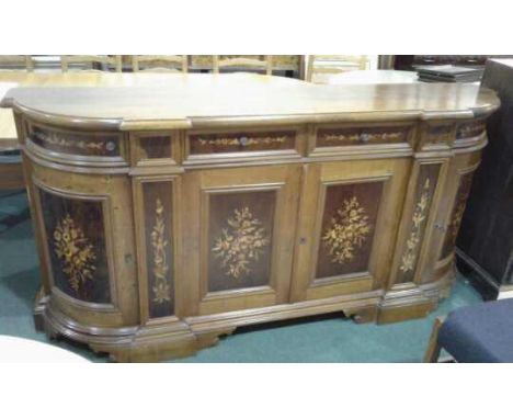 20th Century walnut and inlaid side board, the rectangular top with bow ends and foliate inlaid panel doors raised on a plint