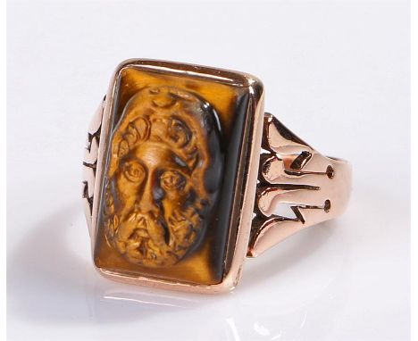 Unusual yellow metal and tigers eye ring, the tigers carved as a Greek god with wide shoulders to the shank, ring size O