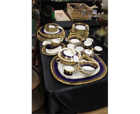 Aynsley bone china service in blue and gold, including cups, saucers, plates dishes etc, (Qty)