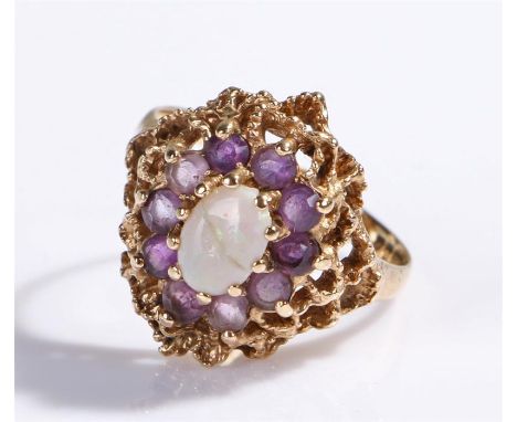 9 carat gold opal and amethyst set ring, the central oval opal with amethyst surround