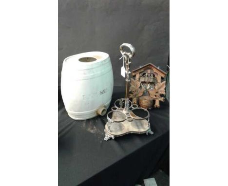 Mixed lot of a wine bottle holder, porcelain barrel and Swiss cuckoo clock, (3)