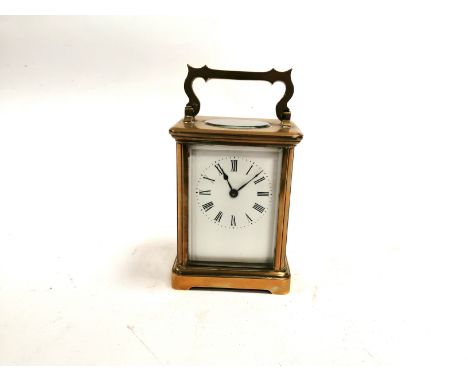A brass carriage clock with enamel dial and Roman numerals engraved for 1899,  with inspection label to the base for the anti
