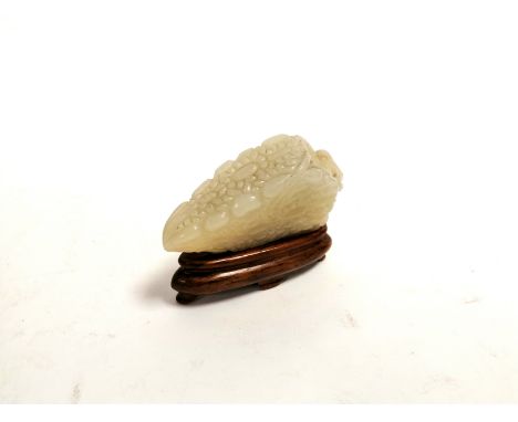 A Chinese jade carving of a leaf,   possibly a snuff bottle, with cork remnant, together with miniature stand, 7cm x 4cm