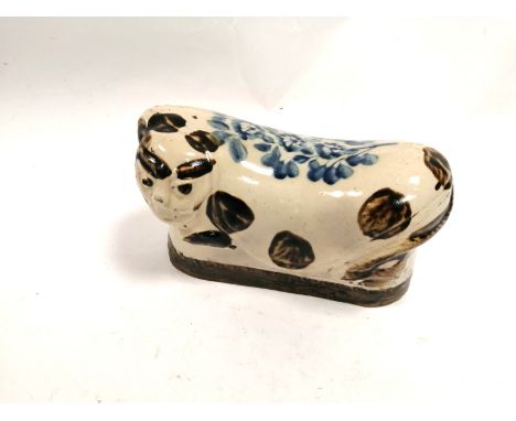 A Chinese ceramic creature, with underglaze blue and brown, possibly a ceramic pillow although having hole to side of face fo