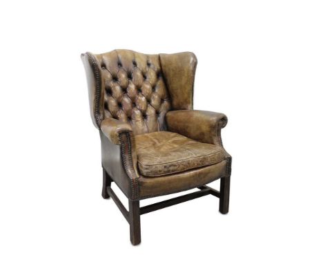 Georgian style leather wing back chair, stud closed brown button upholstery on square supports 