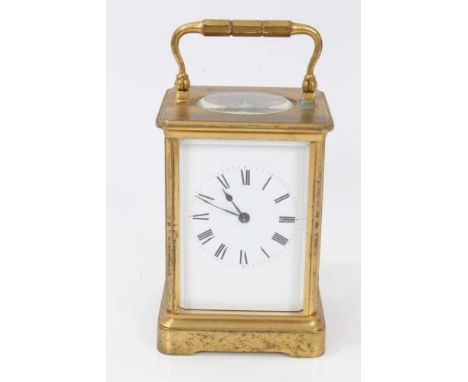 Brass carriage clock with enamel dial and striking movement in traditional case with key, 17 cm high
