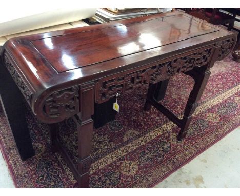 Chinese carved hardwood altar table, with geometric pierced frieze and square supports, 123cm long