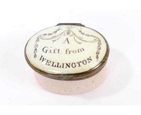 A South Staffordshire enamel patch box 'A Gift from Wellington', cushion form with mirror to underside of lid, 5cm wide