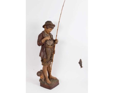Large late 19th/early 20th century Austrian pottery figure of a boy fishing, with bamboo rod and biting fish, in the style of