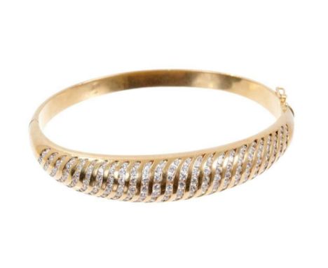18ct gold and diamond hinged bangle with a spiral design of graduated brilliant cut diamonds in channel settingCondition repo