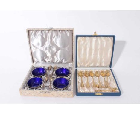 Set of four Danish silver salts of circular form with cobalt blue enamel bowls together with spoons, maker A. Michelsen in fi