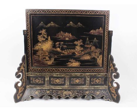 Early 20th century Chinoiserie lacquer firescreen, with rectangular landscape panel in panelled frame with fretwork ornament,