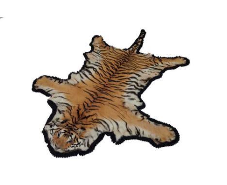 Tiger skin rug with black felt backing, measuring 267cm nose to tail, 182cm paw to paw.Provenance: The vendor's husband was a