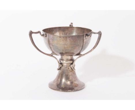 Edwardian silver trophy cup in the Art Nouveau style with three handles, flared column and pedestal foot, engraved presentati