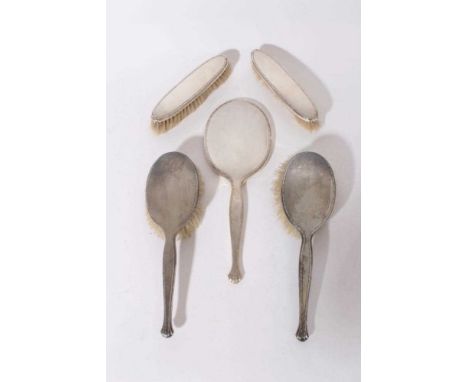 George VI silver hand mirror with engine turned decoration (Birmingham 1937) maker Adie Brothers, together with four brushes 