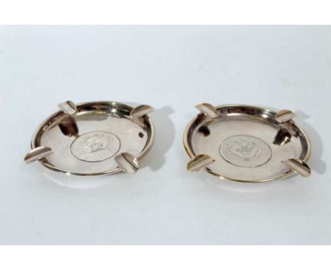 Pair of Chinese silver ashtrays of circular form set with coins, marked Y C Levy, Sterling, all at approximately 5oz, 11.3cm 