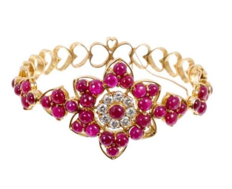 Ruby and diamond hinged bangle with cabochon rubies and brilliant cut diamonds in a large flower head design, with openwork h