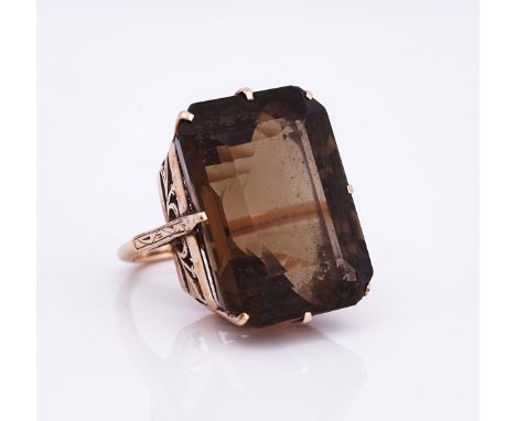 A 9ct gold and smoky quartz ringClaw set with a large cut cornered rectangular step cut smoky quartz, ring size L, gross weig