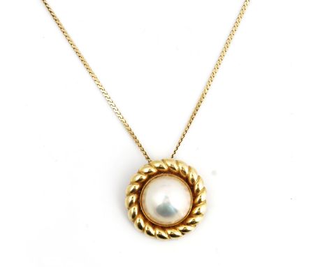 A gold and mabe pearl pendant with a gold neckchainThe mabe pearl mounted within a cable surround, detailed 750, diameter 25.