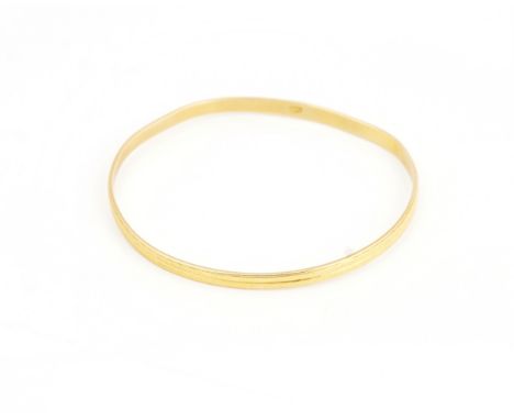A Middle Eastern gold bangleWith two row milled decoration, bears Arabic marks, weight 17.2 gms