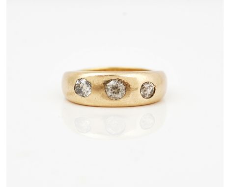 A gold and diamond set three stone ringGypsy set with a row of cushion shaped diamonds, un-marked, ring size R, gross weight 