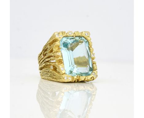 A gold, aquamarine and diamond set ring by Anton FruhaufMounted with a cut cornered rectangular step cut aquamarine, the surr