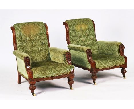 A PAIR OF VICTORIAN OAK EASY ARMCHAIRSWith lions' head finials, 73cm wide; 90cm high (2)Condition Report: The upholstery is l