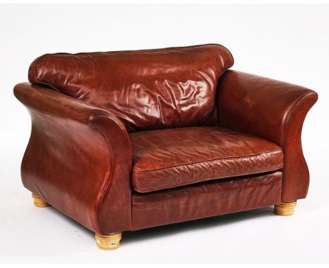 ‘MICHAEL TYLER’: A RAJAH MODEL LEATHER UPHOLSTERED TWO SEAT SOFAOn turned supports, 138cm wide; 74cm high