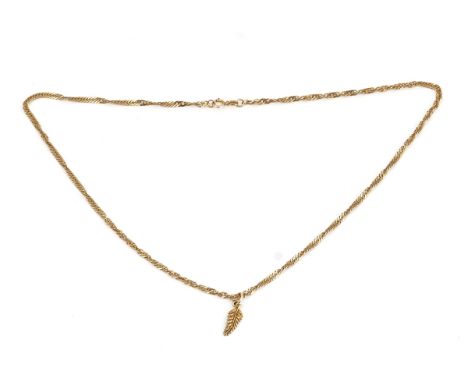 A 9ct gold necklace with a gold New Zealand leaf spray pendantThe multiple link neckchain on a boltring clasp, detailed 9 K, 