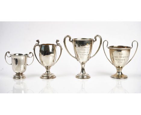 A silver twin handled trophy cup and four further silver twin handled trophy cups (5)The first with mythological animal heads