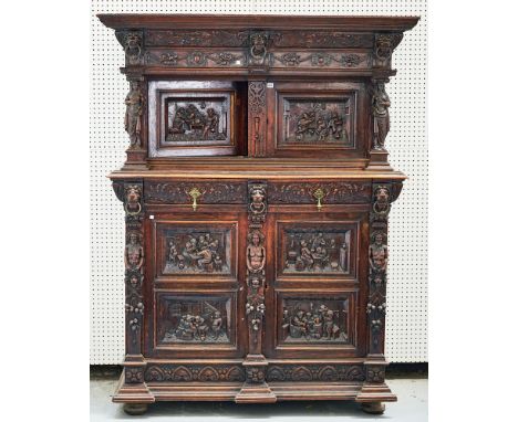 A VICTORIAN CARVED OAK COURT CUPBOARDIn two sections, the panelled doors carved with tavern scenes, two frieze drawers, 142cm