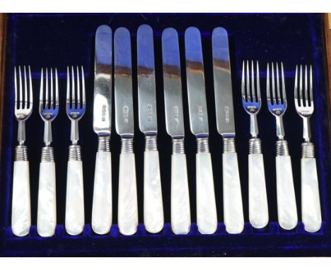 A set of six pairs of silver dessert or fruit knives and forksFitted with mother-of-pearl handles, Sheffield 1911, with an oa