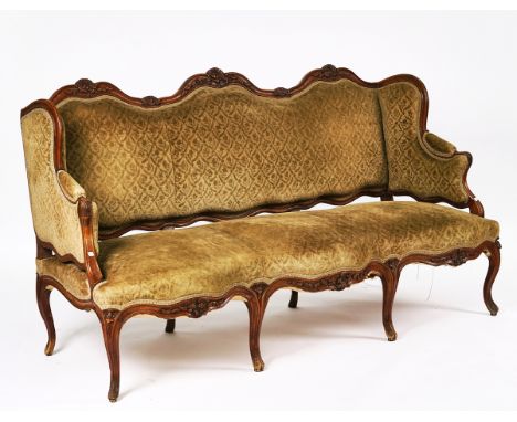 A LOUIS XV CARVED WALNUT FRAMED WINGBACK SOFAWith triple serpentine seat and cabriole supports, 190cm wide; 102cm high