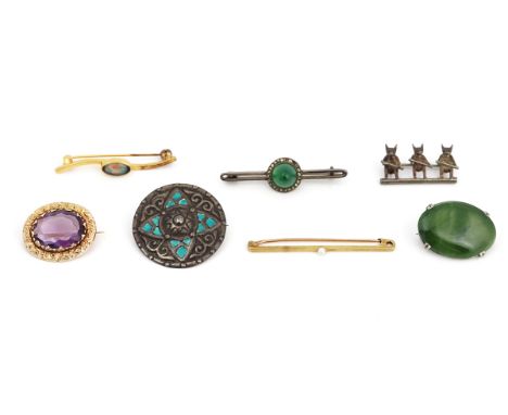An amethyst brooch and six further brooches and pins (7)The gold mounted oval cut amethyst brooch having a floral and scroll 