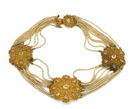A gold, topaz and imitation pearl necklaceCirca 1840, the front formed as three shaped oval Cannatille work topaz set panels,