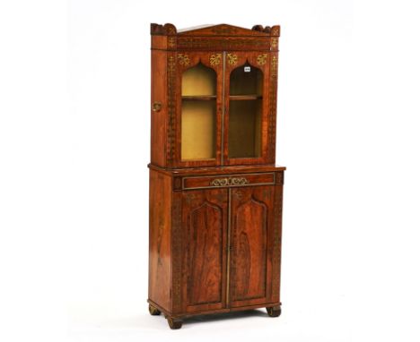 A REGENCY ROSEWOOD AND BRASS INLAID DISPLAY CABINETIn two sections, with concealed frieze drawer, 64cm wide; 153cm highCondit