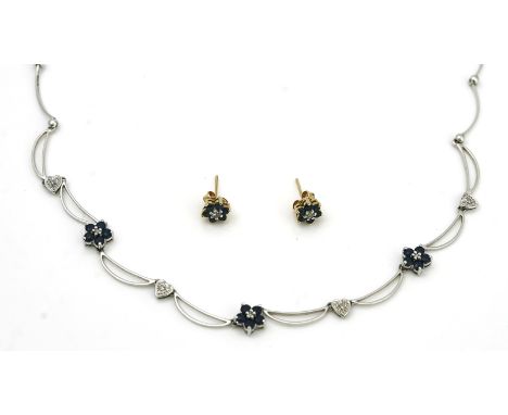 A sapphire and diamond set necklace and a pair of sapphire and diamond earstudsThe white gold necklace, designed as three flo