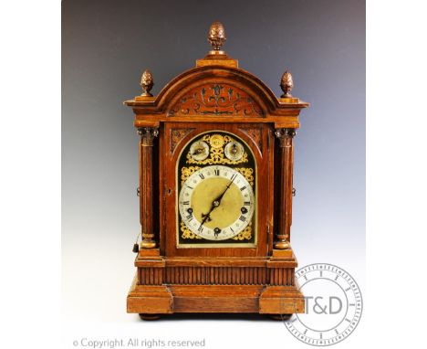 A Victorian carved oak chiming mantel clock, with Roman numeral chapter ring above two subsidiary dials, with a Winterhalder 