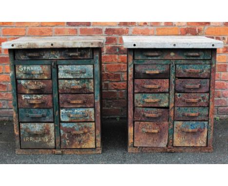 A near pair of vintage industrial metal banks of drawers, with slatted wood tops above an arrangement of one long and ten sho