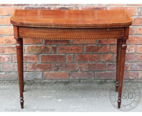 A late George III inlaid mahogany card table, of bow front shape, on turned and tapered legs, 73cm H x 91.5cm W x 45.5cm