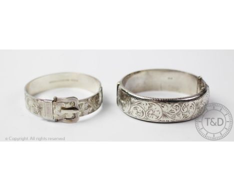 A silver belt/buckle bangle, Birmingham 1976, with chased foliate detail, with another similar, gross weight 62.7gms (2)