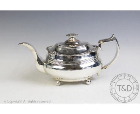 A George III silver teapot, probably Thomas Austin, London 1818, the oval teapot of compressed form decorated with a shell ca