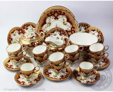 A 19th century twenty nine piece part tea service, pattern number 954, painted with floral swags under a gilt and claret scro