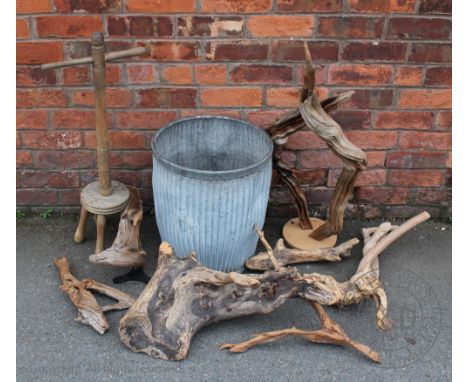 A vintage galvanized wash tub, 47cm high, with a wash dolly, and various pieces of decorative wood previously used for flower