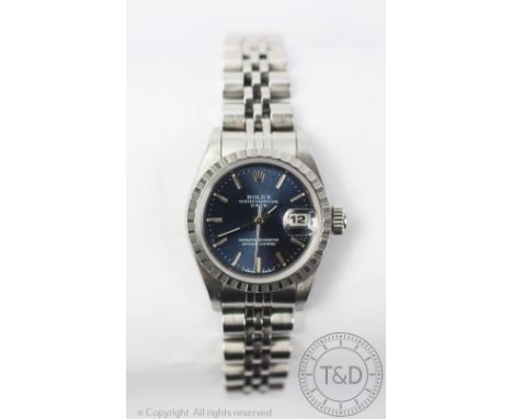 A ladies Rolex Datejust stainless steel wristwatch, the circular blue face with textured bezel enclosing a baton dial with da