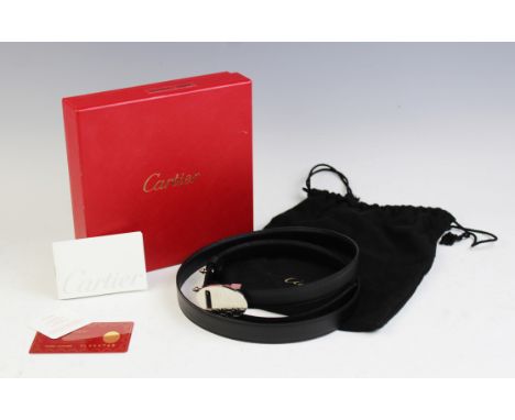 A Cartier ladies black leather belt with silvered oval buckle with monogram, within original box with Cartier certificate, le
