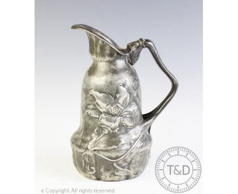 An Art Nouveau pewter ewer, of shaped form and cast with flowers, 21cm CONDITION REPORT: Age wear two tone patina to the surf