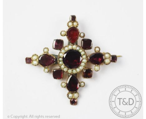 A Georgian garnet and seed pearl set pendant/brooch, the flat cut garnets set within radiating cross design and interspersed 